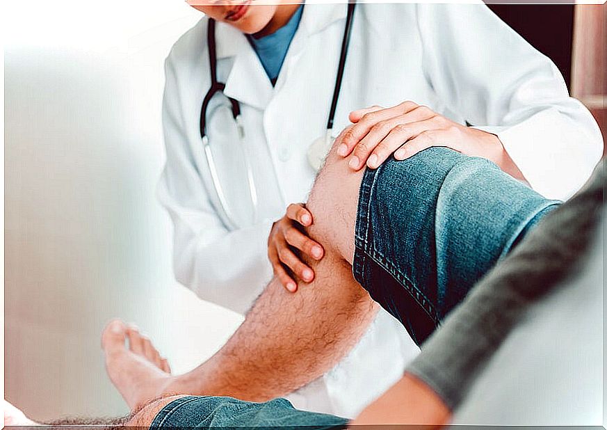 Doctor examining the knee of a patient.