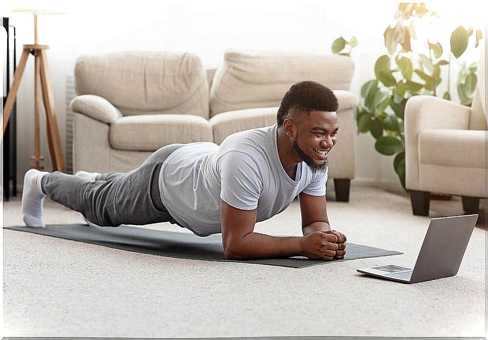 Man on a mat doing exercises at home.