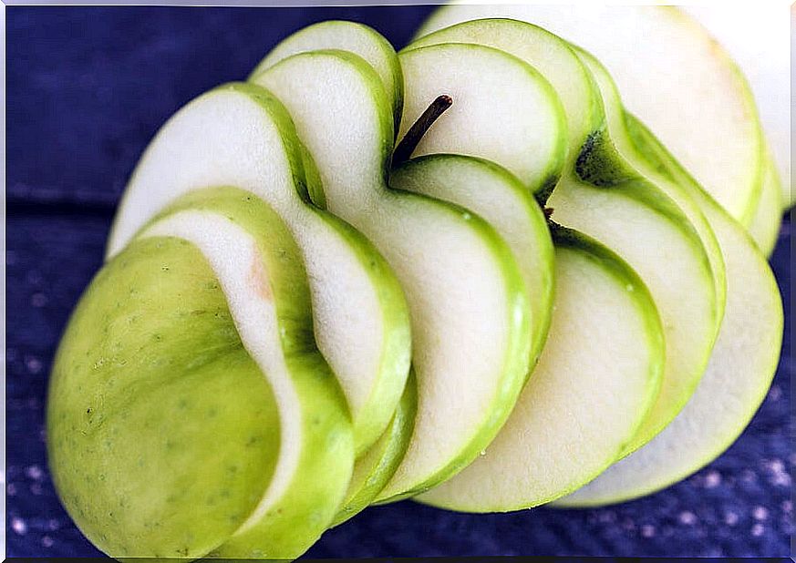 Green apple cut in the shape of hearts.