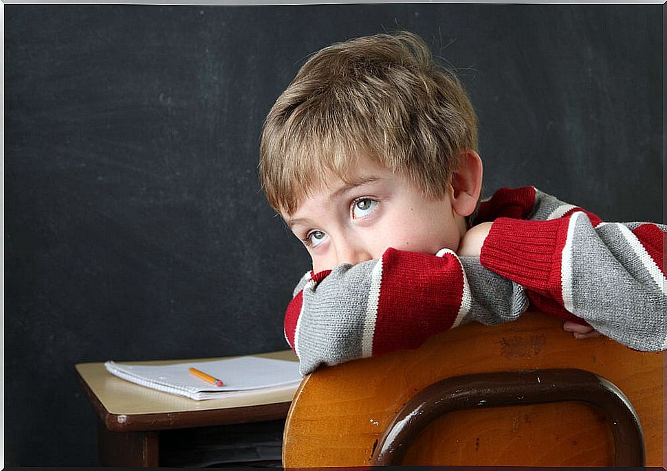 Child sitting at a desk without paying attention: ADHD