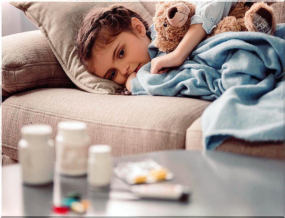 Boy on sofa looking at medicines