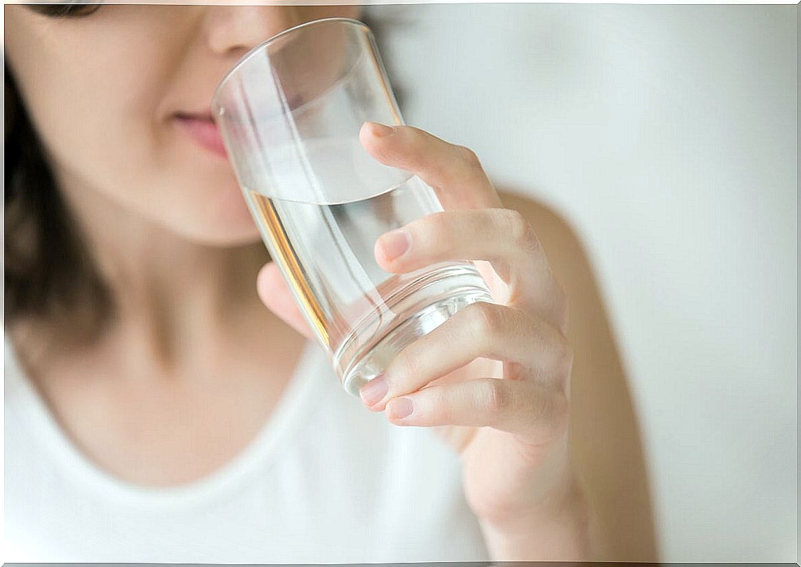 Woman drinks water from glass